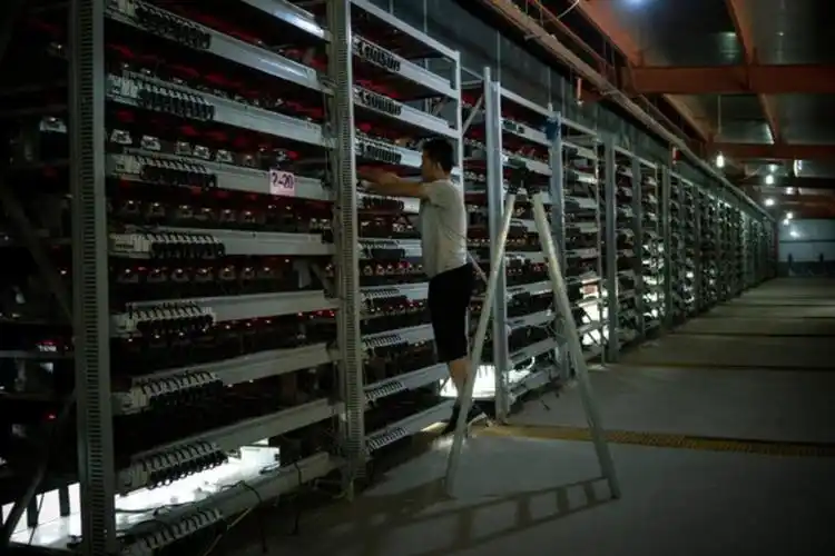 An aerial view of a large-scale mining farm, highlighting the vast infrastructure and energy consumption